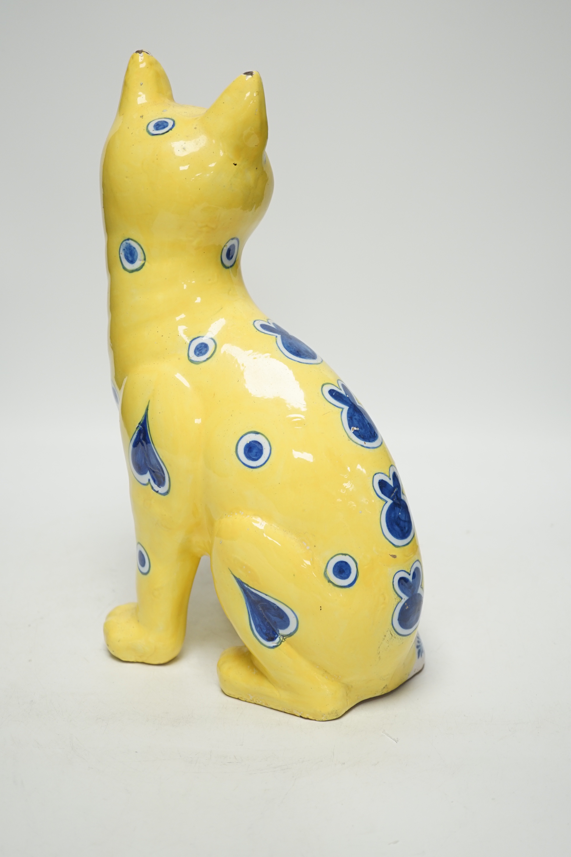 A Gallé yellow glazed model cat with glass eyes, signed E. Gallé, Nancy, 32cm high